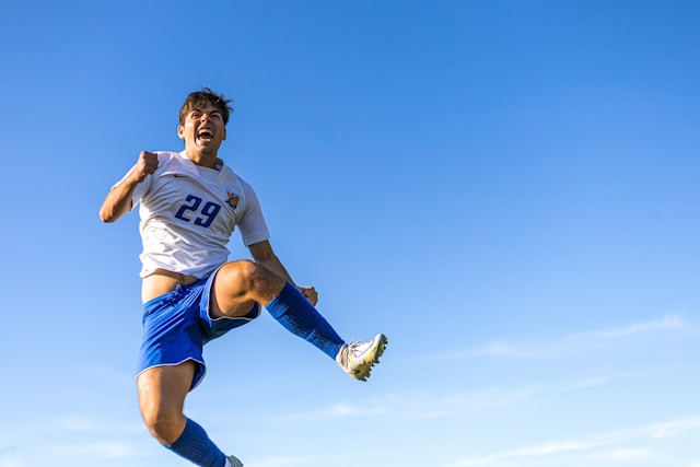 Youth football player jumping for ball during Motherland Cup match